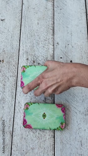 Woman hand splitting a tarot deck into three piles on a wooden table