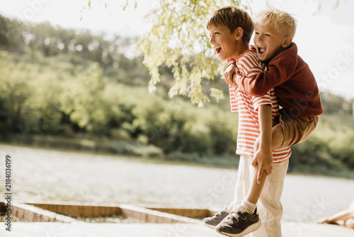 Joyful moments of friendship by the lakeside in a sunny afternoon