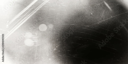 Foto A vintage photographic texture overlays a dark background, featuring subtle scratches, dust, and light leaks that evoke a sense of nostalgia and imperfection