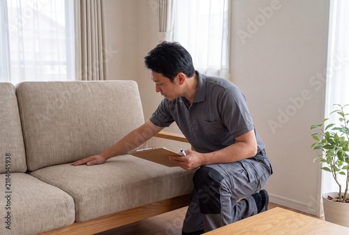 Furniture specialist evaluating sofa fabric quality