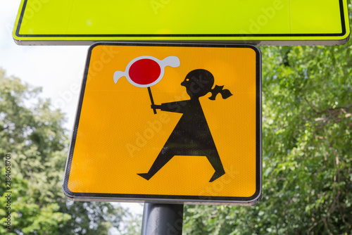 Warning road sign with picture girl with round red signal