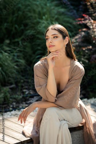Canvastavla Reflective young woman portrait outdoors in casual summer clothing, thoughtful m