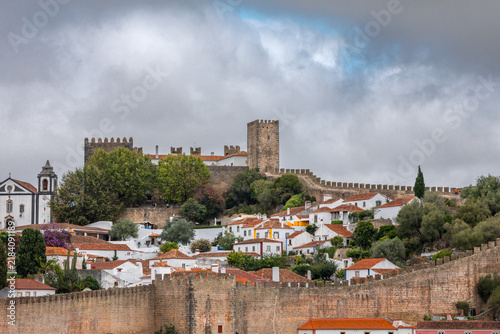 Panoramic cityscape of Obidos showing historic fortifications, white houses, and terracotta roofs - Portugal