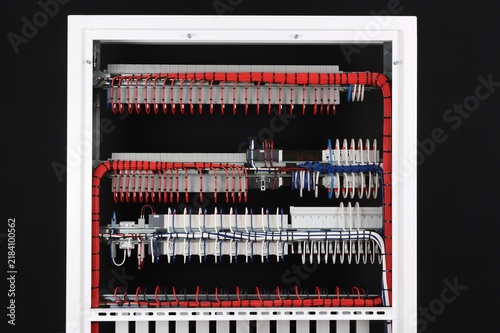 The reverse side of the electrical switchboard. The connected wires are tied with plastic ties.