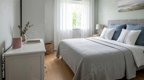 Cozy bedroom interior with a comfortable bed and natural light from a window