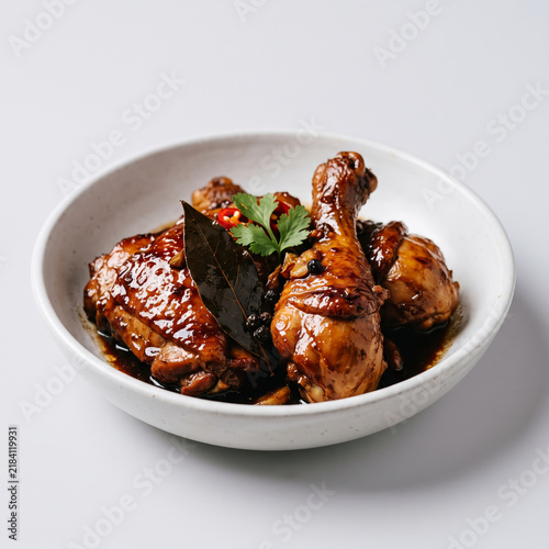 Filipino chicken adobo in a white bowl overhead view