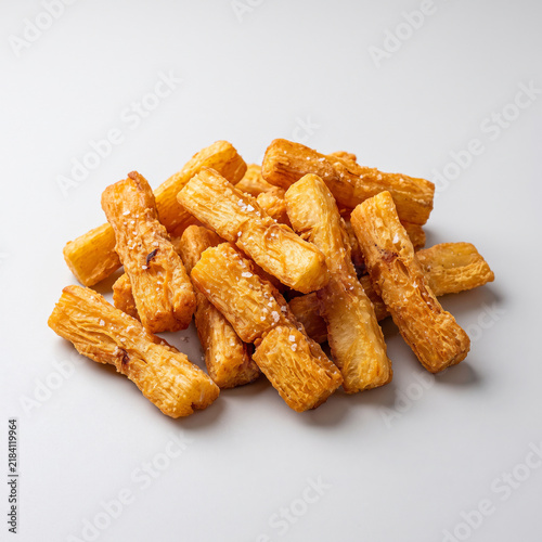 fried yuca root golden crispy cassava sticks white background