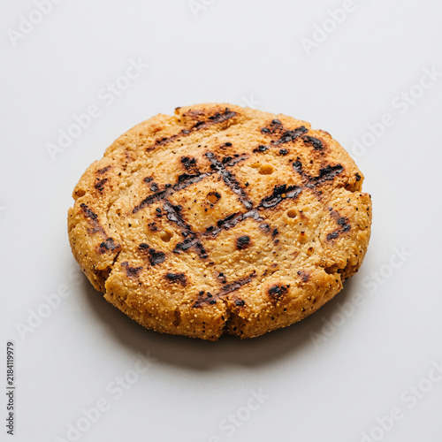 Grilled arepa flatbread isolated on white background