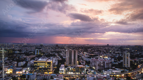 Photography Bangalore urban skyline illuminated beneath a dramatic evening sky