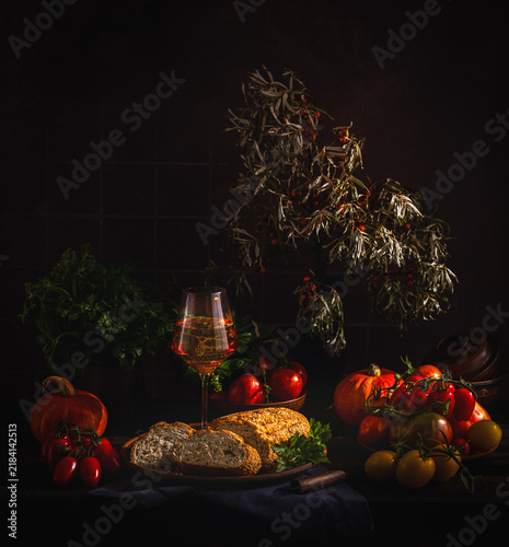 Autumnal still life with wine, bread, and harvest vegetables