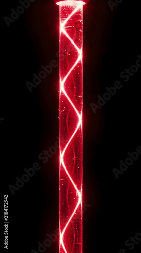 Red optical fiber cable with illuminated spiral pattern against a black background