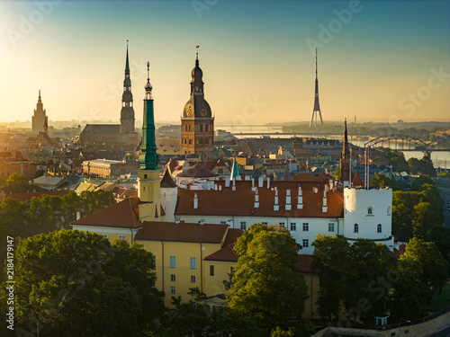 Aerial panoramic view of Old Riga during sunrise in summer, Riga Castle in foreground