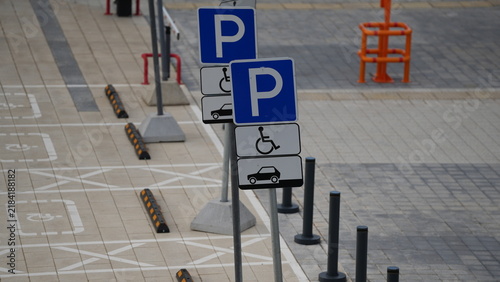 Fotografie Designated accessible parking spaces with wheelchair signs and traffic markings,