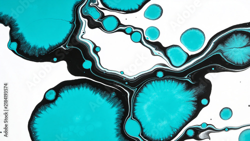 Turquoise and black ink swirls on a white background, creating an abstract pattern
