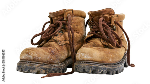 Foto Isolated well-worn brown leather hiking boots with dirty soles and untied shoelaces