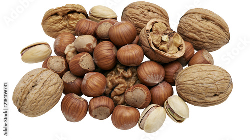 Isolated pile of mixed fresh nuts including walnuts, hazelnuts, and pistachios, healthy snack food.