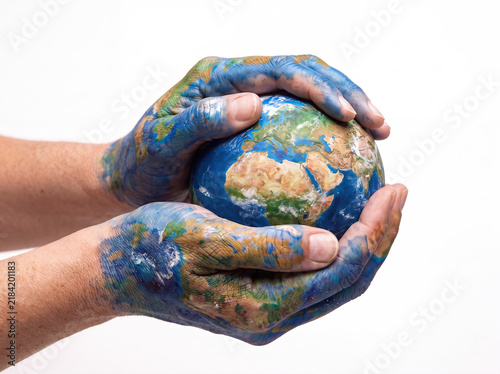 Obraz w ramie Painted hands holding a miniature earth globe, symbolizing support for global sustainability and world environmental caring