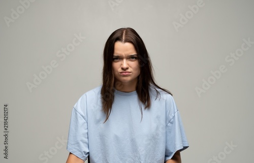 Принти на полотні Young woman feeling frustration and displeasure, expressing annoyance with a fro
