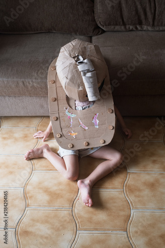Fotografie Child Wearing a Homemade Cardboard Costume Indoors