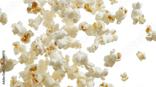 Фотография Isolated numerous pieces of fresh and delicious popcorn falling, perfect airy sn