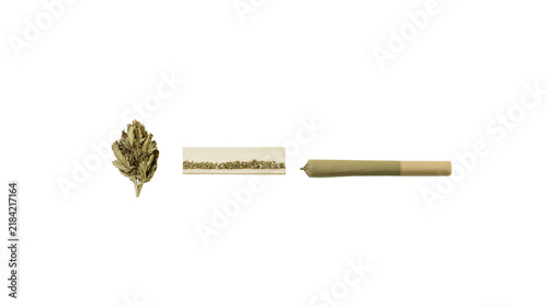 Isolated cannabis flower bud, ground marijuana in rolling paper, and finished pre-roll joint