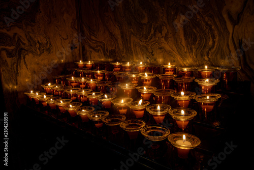 Canvastavla Burning Votive Candles in Glass Holders Inside Dark Church