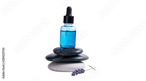 Фотография Isolated blue dropper bottle with essential oil on spa stones and lavender for aromatherapy