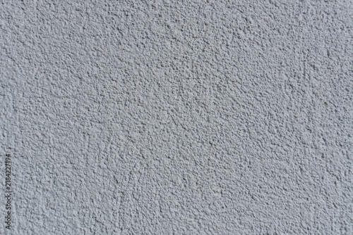 Coarse, light gray stucco wall texture., Close-up of rough, bumpy concrete render with granular cement patterns. Perfect for a minimalist abstract architectural background.
