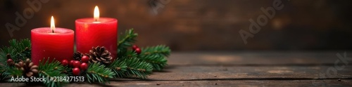 Three lit red Advent candles, fir branches, rustic wood background, serenity, still life, dark