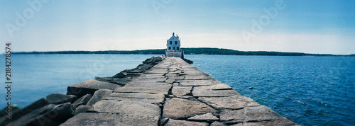 Panoramic view of the historic Rockland Harbor Breakwater Light sitting at the end of a nearly one-mile granite stone causeway in Rockland, Maine