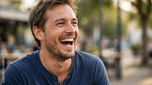Happy man laughing heartily in an outdoor setting