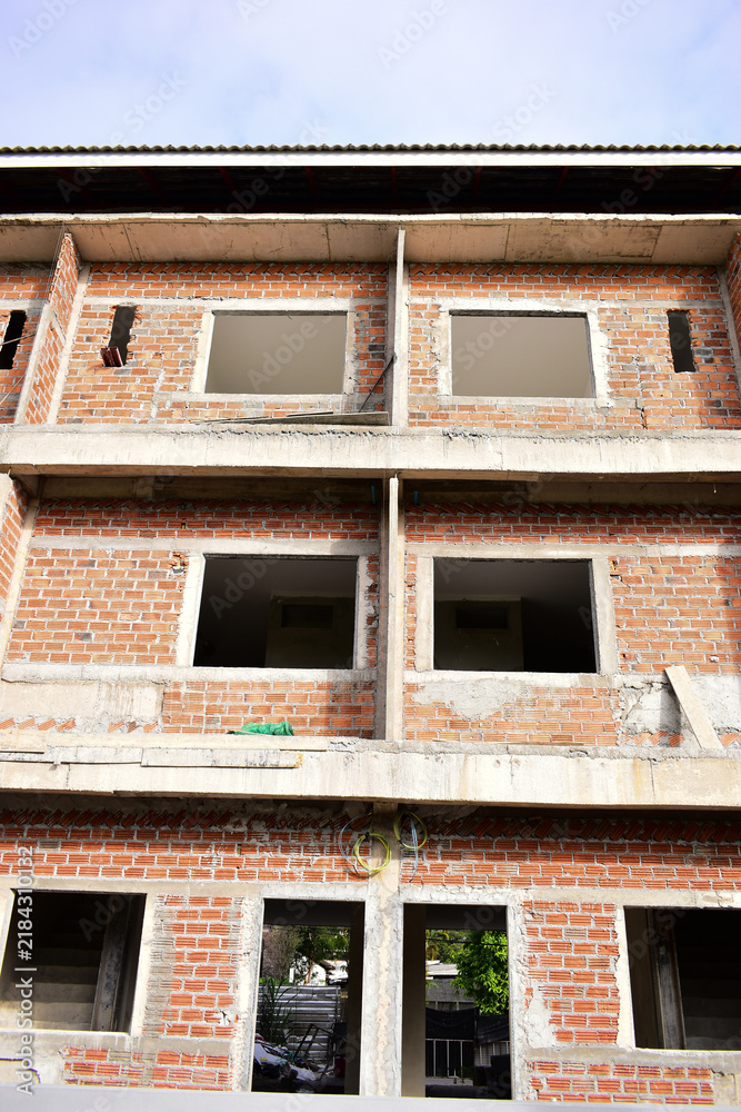 Obraz premium exterior view of brick house under construction with concrete structure