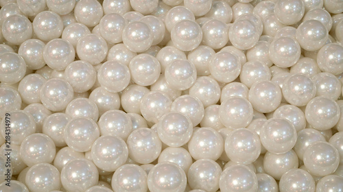 Close-up Image of Smooth White Pearls with Glossy Shine Creating an Elegant Background Texture