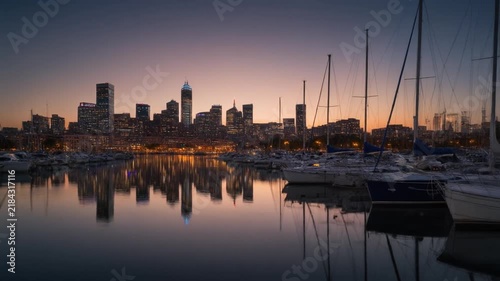 Sunset over chaffers marina with city skyline and water reflections