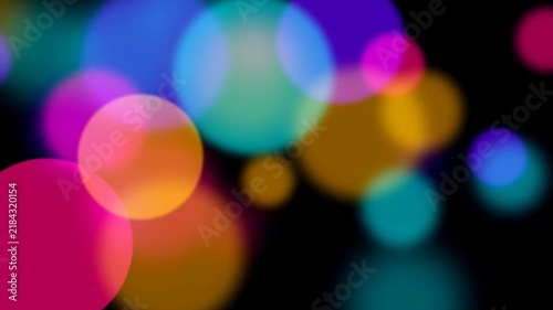 Abstract colorful bokeh light circles on black background for motion graphics overlay.