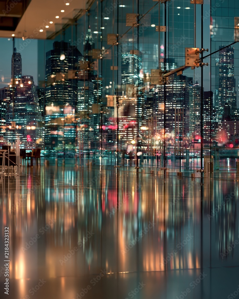 Fototapeta premium View from luxurious modern office through transparent solar glass windows overlooking glowing futuristic green city skyline at evening twilight.