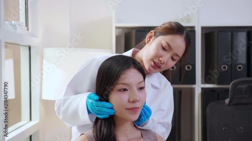 Asian woman doctor examining face female patient in medical clinic, dermatology specialist touching skin for cosmetic treatment, healthy wellness service, aesthetic dermatology and wellness business.
