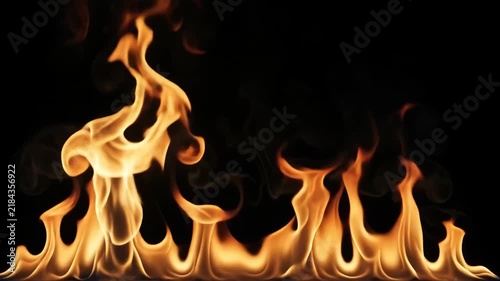 Dancing orange fire and glowing fireplace flame create warm dramatic background with light, heat, warmth, flowing smoke, dark atmosphere, and elegant seasonal interior design contrast