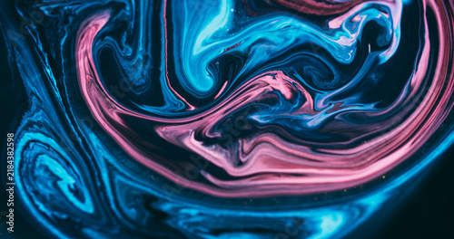 Shiny ink. Acrylic flow. Blur blue pink purple color mix sparkling marble texture glitter fluid floating on abstract art background.