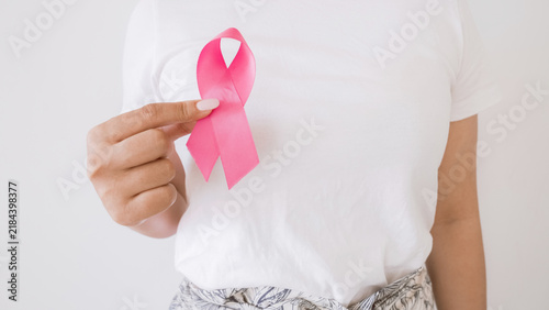 Woman hand holding pink ribbon, Breast cancer awareness and October Pink day, world cancer day
