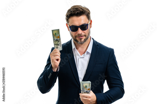 Konstfotografi Incognito businessman in dark sunglasses holds dollars