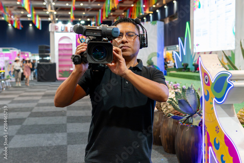 Cameraman recording live event for broadcasting production