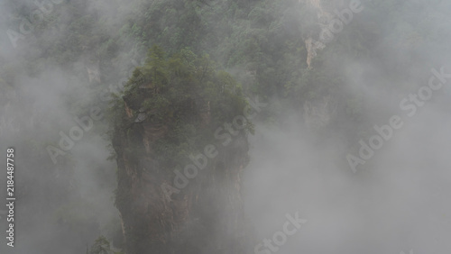 Quadro su tela A high rock pillar is shrouded in thick fog
