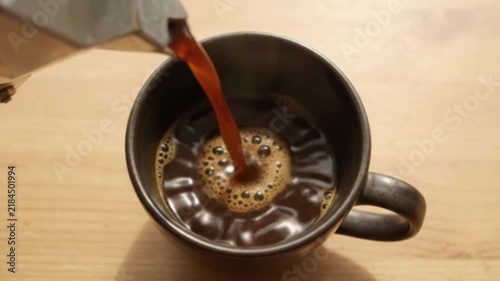 Dark espresso stream and foam in ceramic cup 4K HD
