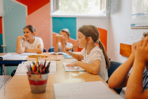 Bild auf Leinwand Students learning in classroom with diverse classmates
