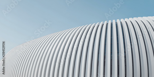 Minimalist white ribbed building facade against pale blue sky architecture desi