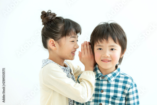 Plakat w ramie 内緒話しをする女の子と男の子