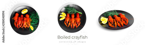 Foto Boiled crayfish with dill and lemon on black plate isolated on a white background