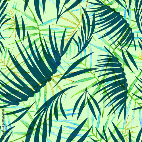 Palm leaves seamless tropical print on a green jugle background