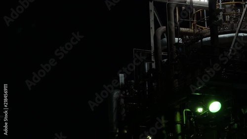 Green Industrial Light Illuminating Pipes and Machinery at Night in Chidoricho Kawasaki